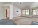 Spacious living room featuring large windows, a fireplace, and neutral-colored walls at 4612 Standing Bluff Way, Las Vegas, NV 89130