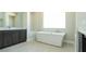 Modern bathroom with a freestanding tub, dual vanities, and large window for natural light at 4630 Blushing Dawn Ave, Las Vegas, NV 89118