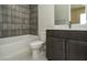 Bathroom features a tub, tiled accent wall, and vanity with cabinet at 4630 Blushing Dawn Ave, Las Vegas, NV 89118