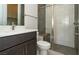 Well-lit bathroom shows a vanity, toilet, and tiled shower at 4630 Blushing Dawn Ave, Las Vegas, NV 89118