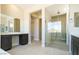 Bright bathroom boasts a glass-enclosed shower and a vanity with a large mirror at 4630 Blushing Dawn Ave, Las Vegas, NV 89118