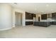 Open-concept kitchen and living area with sleek dark cabinets, recessed lighting, and tile flooring at 4630 Blushing Dawn Ave, Las Vegas, NV 89118