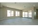 Bright living room with tile flooring, large windows, and sliding glass doors to the outdoor space at 4630 Blushing Dawn Ave, Las Vegas, NV 89118