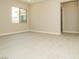 Neutral living room with white trim, a window and light tile flooring at 4630 Blushing Dawn Ave, Las Vegas, NV 89118