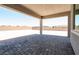 Covered patio with brick pavers and view of the backyard and privacy wall at 4630 Blushing Dawn Ave, Las Vegas, NV 89118