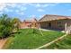 Spacious backyard with green lawn, covered patio, and a swing set, perfect for outdoor activities at 4837 River Splash Ave, Las Vegas, NV 89131