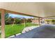 Covered patio and backyard with green grass and a swing set at 4837 River Splash Ave, Las Vegas, NV 89131