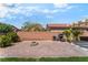 Private backyard with brick patio, fire pit, mature landscaping and built-in outdoor kitchen at 4837 River Splash Ave, Las Vegas, NV 89131