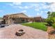 Backyard patio with brickwork, a fire pit, and a covered seating area, ideal for entertaining at 4837 River Splash Ave, Las Vegas, NV 89131