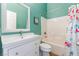 Bright bathroom featuring a modern vanity, tub with tile surround, and turquoise-colored walls at 4837 River Splash Ave, Las Vegas, NV 89131