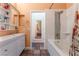 Bright bathroom featuring a modern vanity, tub with tile surround, and neutral-toned walls at 4837 River Splash Ave, Las Vegas, NV 89131