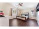 Cozy bedroom with a ceiling fan, natural light, and hardwood floors at 4837 River Splash Ave, Las Vegas, NV 89131