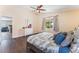 Serene bedroom with hardwood floors, natural light, and ceiling fan at 4837 River Splash Ave, Las Vegas, NV 89131