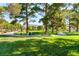 Picturesque community park featuring lush green lawns, mature trees, and walking paths at 4837 River Splash Ave, Las Vegas, NV 89131