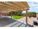 Large covered patio with concrete and brickwork, offering an ideal area for grilling and outdoor dining at 4837 River Splash Ave, Las Vegas, NV 89131
