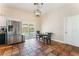 Bright dining area near stainless steel refrigerator with sliding glass door providing backyard access at 4837 River Splash Ave, Las Vegas, NV 89131