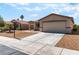 Single-story house with desert landscaping and a spacious driveway leading to a two-car garage at 4837 River Splash Ave, Las Vegas, NV 89131