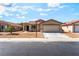 Charming single-story home with low maintenance landscaping and a two-car garage at 4837 River Splash Ave, Las Vegas, NV 89131