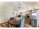 Inviting open-concept kitchen and dining area with modern appliances and tiled floor at 4837 River Splash Ave, Las Vegas, NV 89131