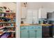 Bright kitchen with white cabinets, a pantry, and stainless steel sink at 4837 River Splash Ave, Las Vegas, NV 89131