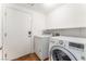 Laundry room featuring tile floors, washer and dryer and door to the exterior at 4837 River Splash Ave, Las Vegas, NV 89131