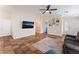 Spacious living room featuring tile flooring, a ceiling fan, and a view into the dining and kitchen area at 4837 River Splash Ave, Las Vegas, NV 89131