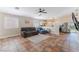 Open-concept living room featuring tile floors and a seamless flow into the dining and kitchen area at 4837 River Splash Ave, Las Vegas, NV 89131