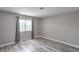 This cozy bedroom is illuminated by natural light from the window and gray-toned flooring at 5219 Caliente St # 11, Las Vegas, NV 89119