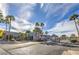Community entrance with palm trees, gate and blue skies at 5219 Caliente St # 11, Las Vegas, NV 89119