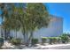 Home exterior with manicured shrubbery and mature trees at 5219 Caliente St # 11, Las Vegas, NV 89119