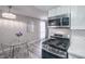 Eat-in kitchen shows gas range, stainless steel appliances, and modern lighting at 5219 Caliente St # 11, Las Vegas, NV 89119