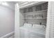 Functional laundry closet with stacked washer and dryer and shelving at 5219 Caliente St # 11, Las Vegas, NV 89119