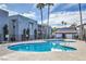Beautiful community pool surrounded by lush landscaping and well-maintained buildings at 5219 Caliente St # 11, Las Vegas, NV 89119