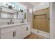 Bathroom with double vanity, modern fixtures, and a walk-in shower with wood paneling at 5321 Marietta Ave, Las Vegas, NV 89108