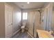 Well-lit bathroom with a glass shower, toilet, and window, showcasing a clean design at 5461 Dungaree St, Las Vegas, NV 89118