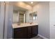 Elegant bathroom featuring double sinks, dark cabinetry, and a large framed mirror at 5461 Dungaree St, Las Vegas, NV 89118