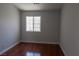 Bedroom featuring wood laminate floors, neutral paint, and a window at 5461 Dungaree St, Las Vegas, NV 89118