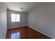 Well lit bedroom featuring wood laminate floors and a large window at 5461 Dungaree St, Las Vegas, NV 89118