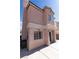 Exterior side view of a two-story home with stucco walls and a concrete patio at 5461 Dungaree St, Las Vegas, NV 89118