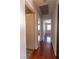 Hallway featuring wood laminate floors and white painted doors at 5461 Dungaree St, Las Vegas, NV 89118