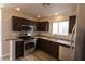 Modern kitchen features stainless steel appliances, dark wood cabinets and modern countertops at 5461 Dungaree St, Las Vegas, NV 89118