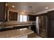 Modern kitchen featuring stainless steel appliances, granite countertops, and dark cabinetry at 5461 Dungaree St, Las Vegas, NV 89118