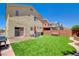 Private backyard featuring a manicured lawn, patio area, and a barbecue perfect for outdoor entertaining and relaxation at 5516 Tantalum Ln, Las Vegas, NV 89122