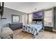 Bedroom with wood-look floors, gray walls, bedside tables and neutral bedding at 5516 Tantalum Ln, Las Vegas, NV 89122