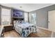 Comfortable bedroom with a large window, wood-look floors, and neutral decor at 5516 Tantalum Ln, Las Vegas, NV 89122