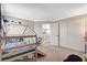 Bright bedroom features a bunk bed with slide, closet space, and easy access to other areas of the house at 5516 Tantalum Ln, Las Vegas, NV 89122