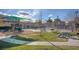 Community park with a playground, picnic tables, and a grill surrounded by lush landscaping and green spaces at 5516 Tantalum Ln, Las Vegas, NV 89122