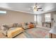Comfortable living room with neutral walls, ceiling fan, and tile floors, creating a welcoming and airy atmosphere at 5516 Tantalum Ln, Las Vegas, NV 89122