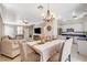 Open-concept living room and kitchen with a dining table and modern appliances at 5516 Tantalum Ln, Las Vegas, NV 89122