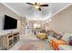 Open living area with tile floors, ceiling fan, and comfortable seating, ideal for relaxation and entertainment at 5516 Tantalum Ln, Las Vegas, NV 89122